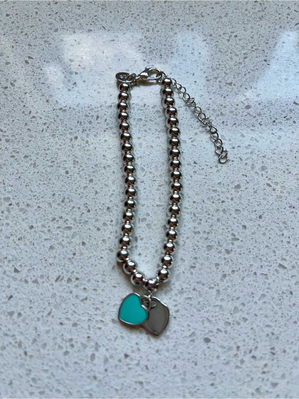 Silver-tone bracelet with two heart charms